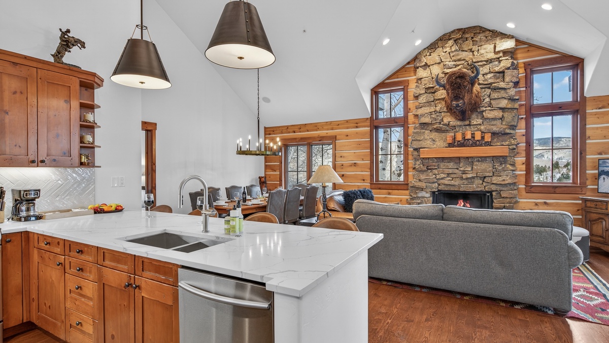 Your open-concept haven blends rustic charm with modern luxury, featuring a gourmet kitchen island and cozy stone fireplace.