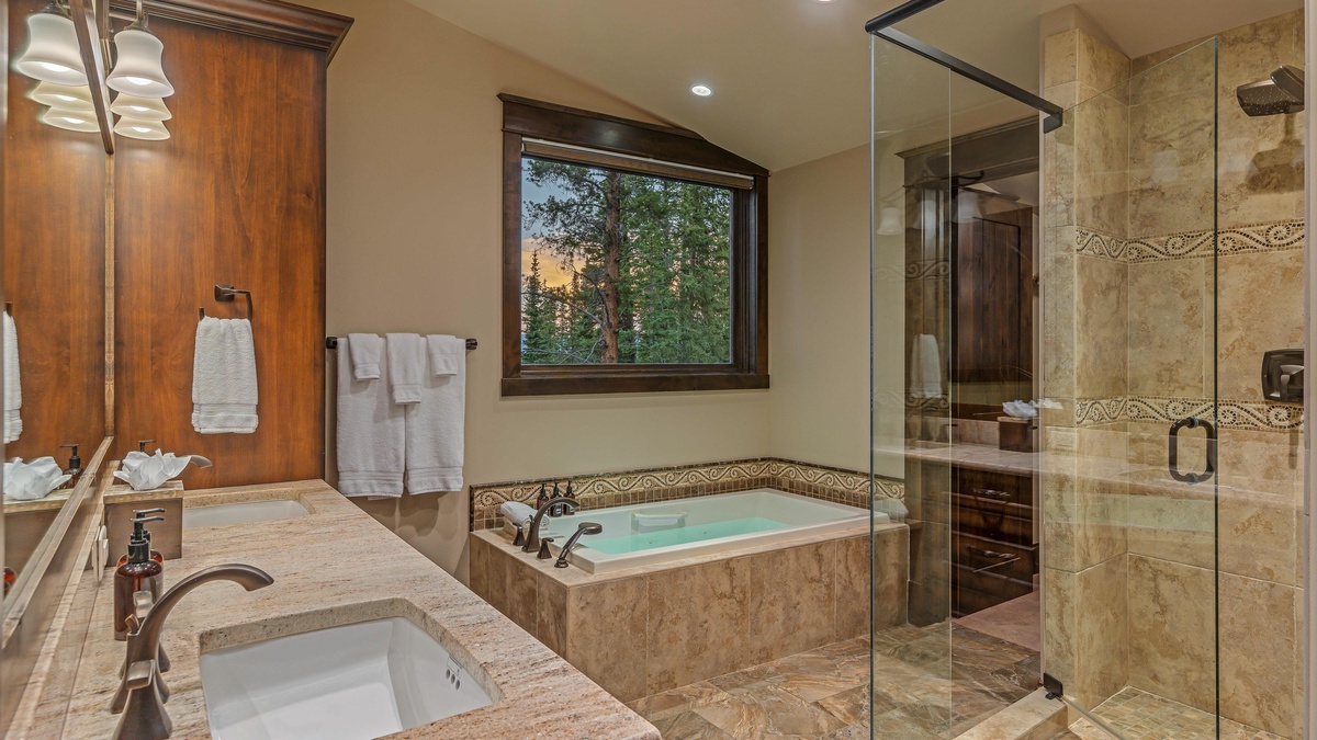 Bedroom 1, Main Level - Primary ensuite on main level with dual vanities, soaking tub, shower, and walk-in closet