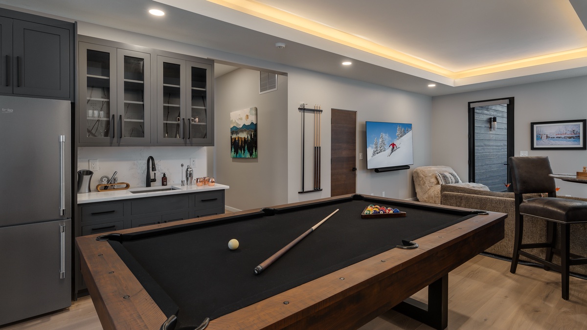 Family room with billiards, bar, and TV on lower level