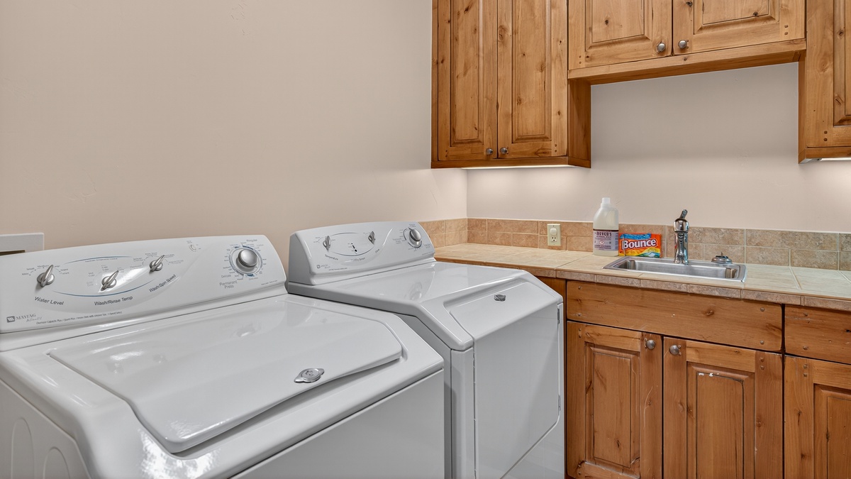Laundry, Lower Level - Washer and dryer with storage cabinetry