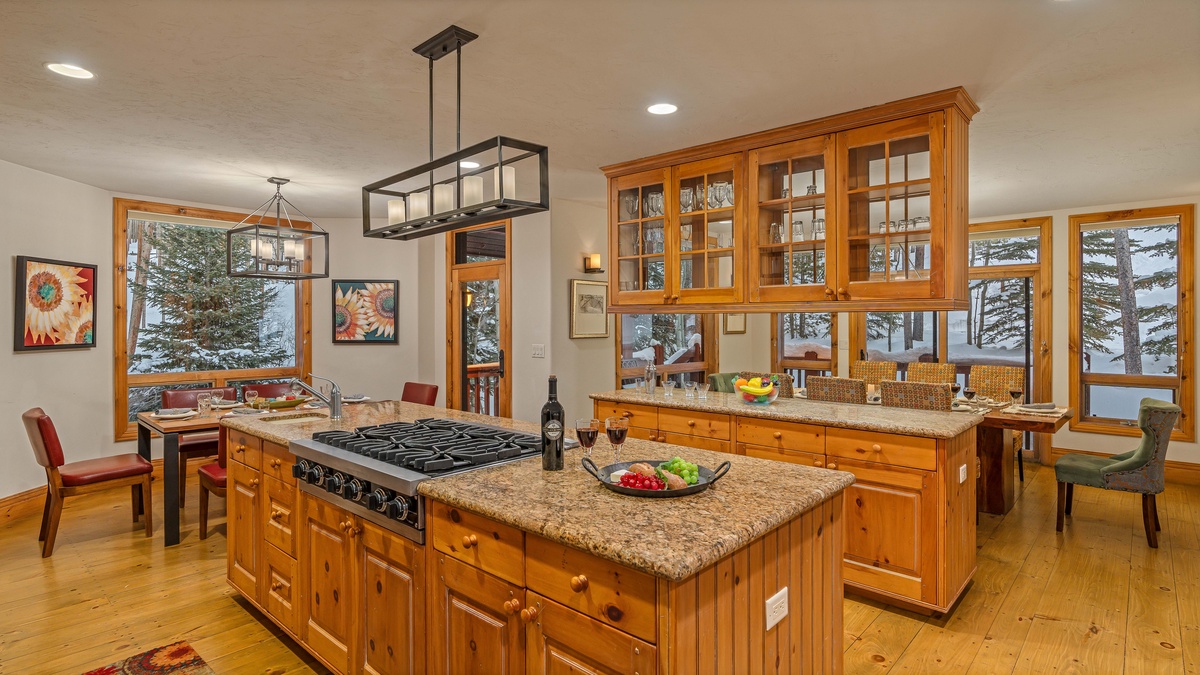Kitchen leading into dining area, breakfast nook, and deck access