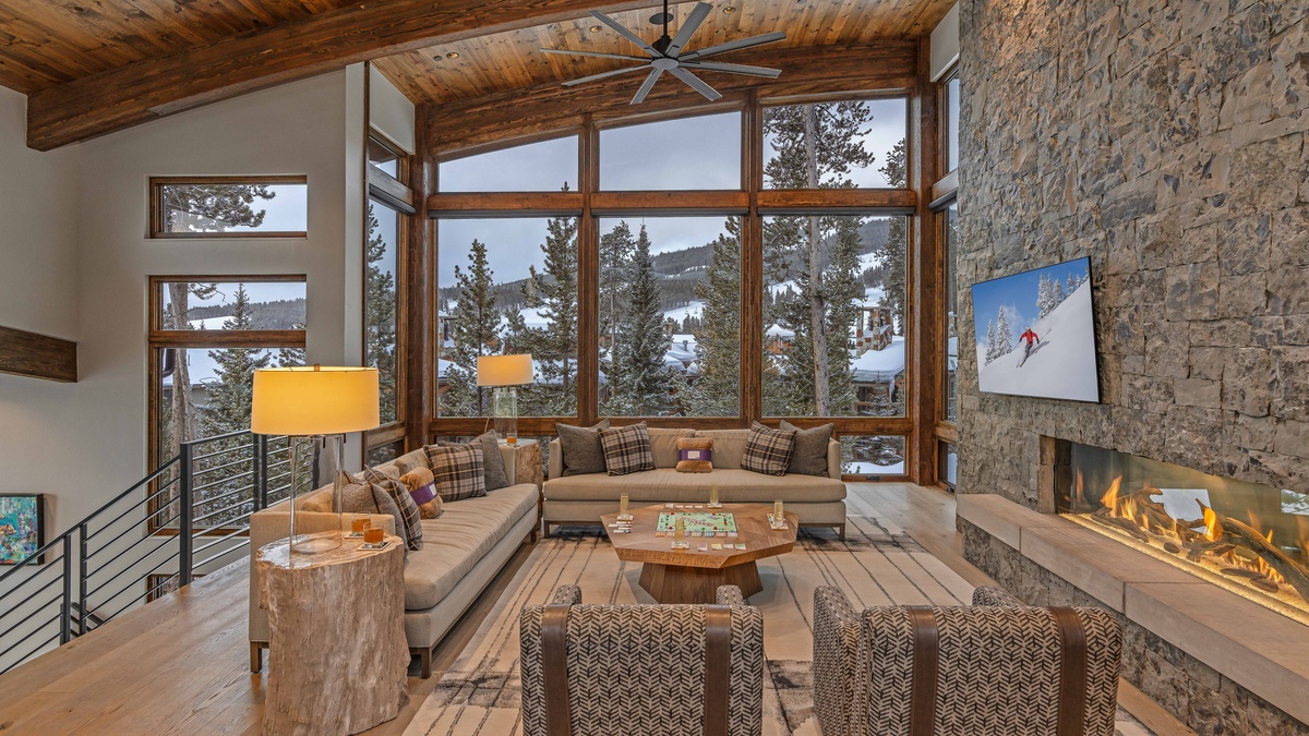 Spacious great room with TV, gas fireplace, and mountain resort views