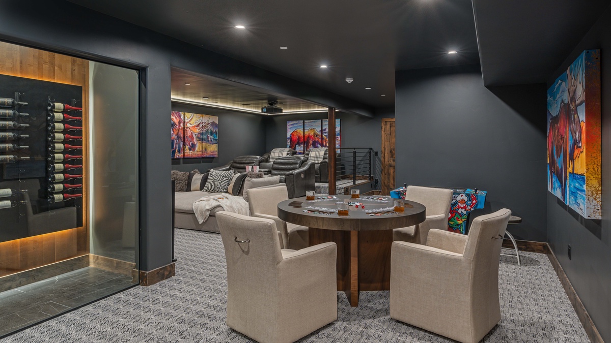 Theater room on lower level with poker table and arcade game