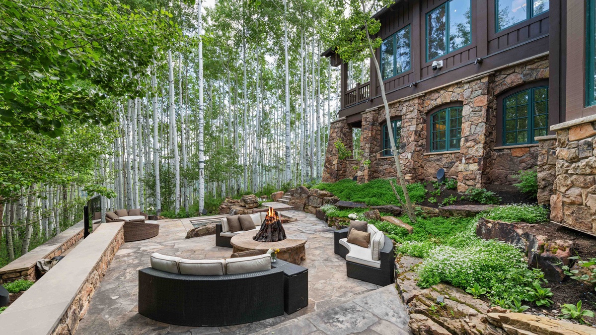 Lush greenery surrounding the expansive outdoor patio