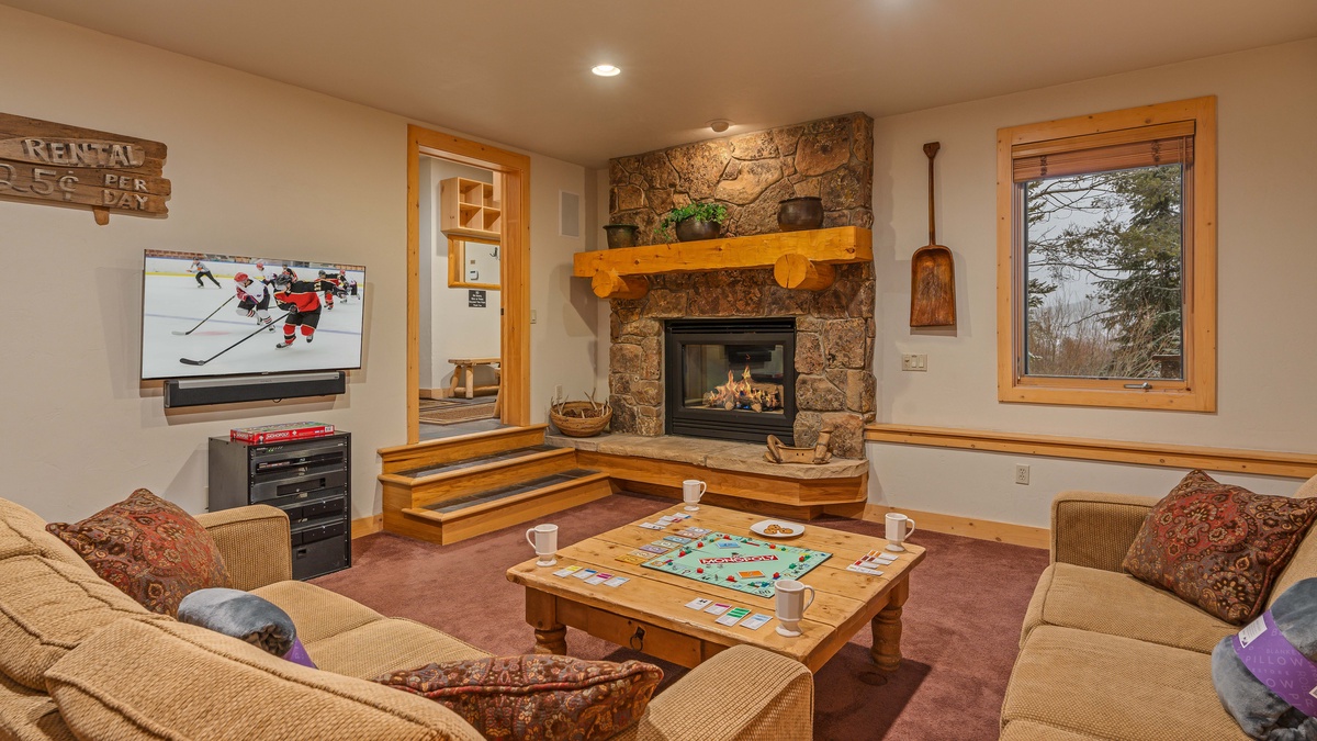 Lower level family room with gas fireplace and TV