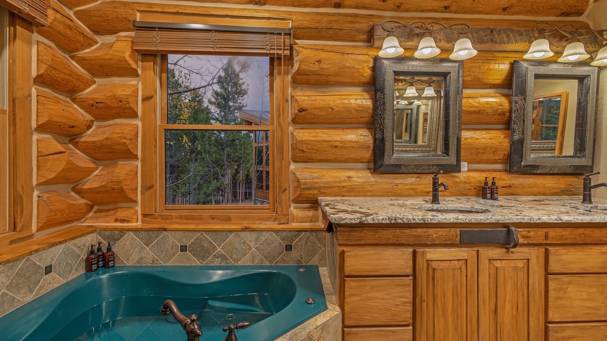 Bedroom 1, Main level - Primary ensuite on main level with double sinks, spa tub, and shower