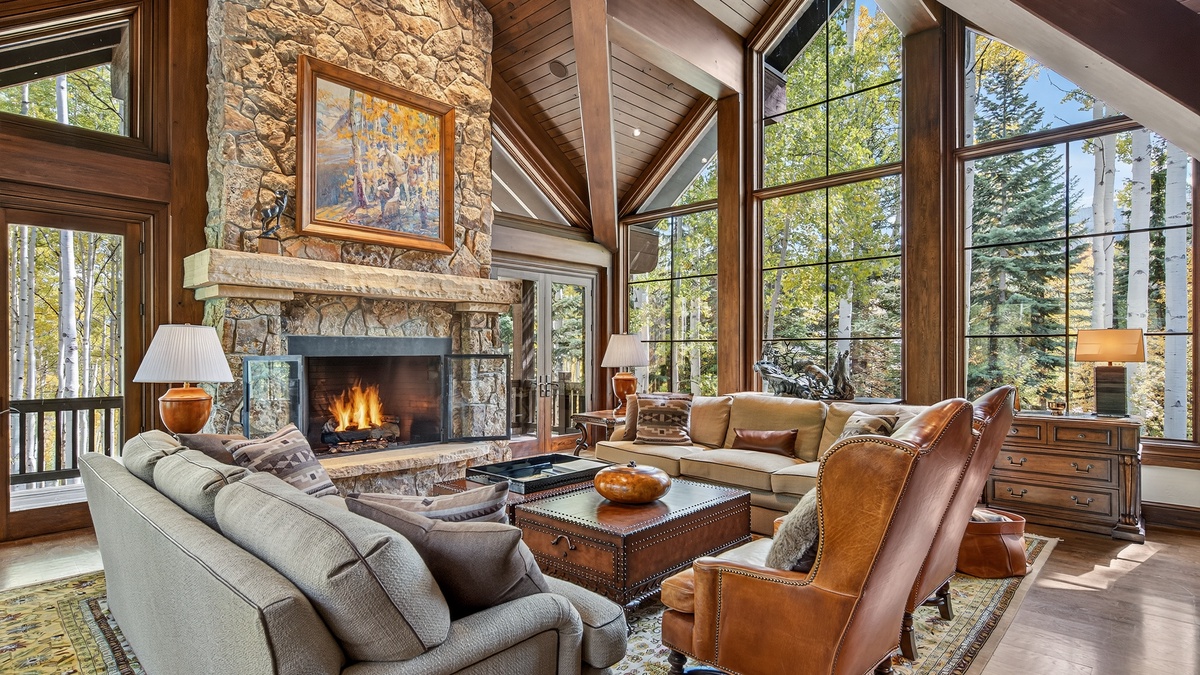 Aspen trees surround the great room floor-to-ceiling windows