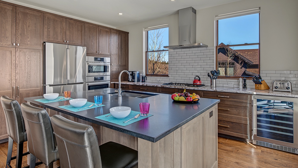 Kitchen, Main Level - Island with bar seating and stainless steel appliances