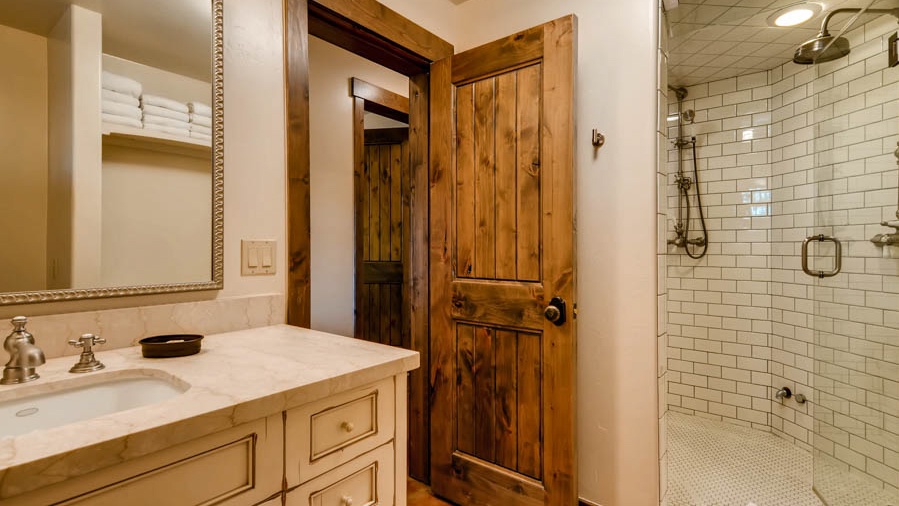 Hall bath on lower level with steam shower