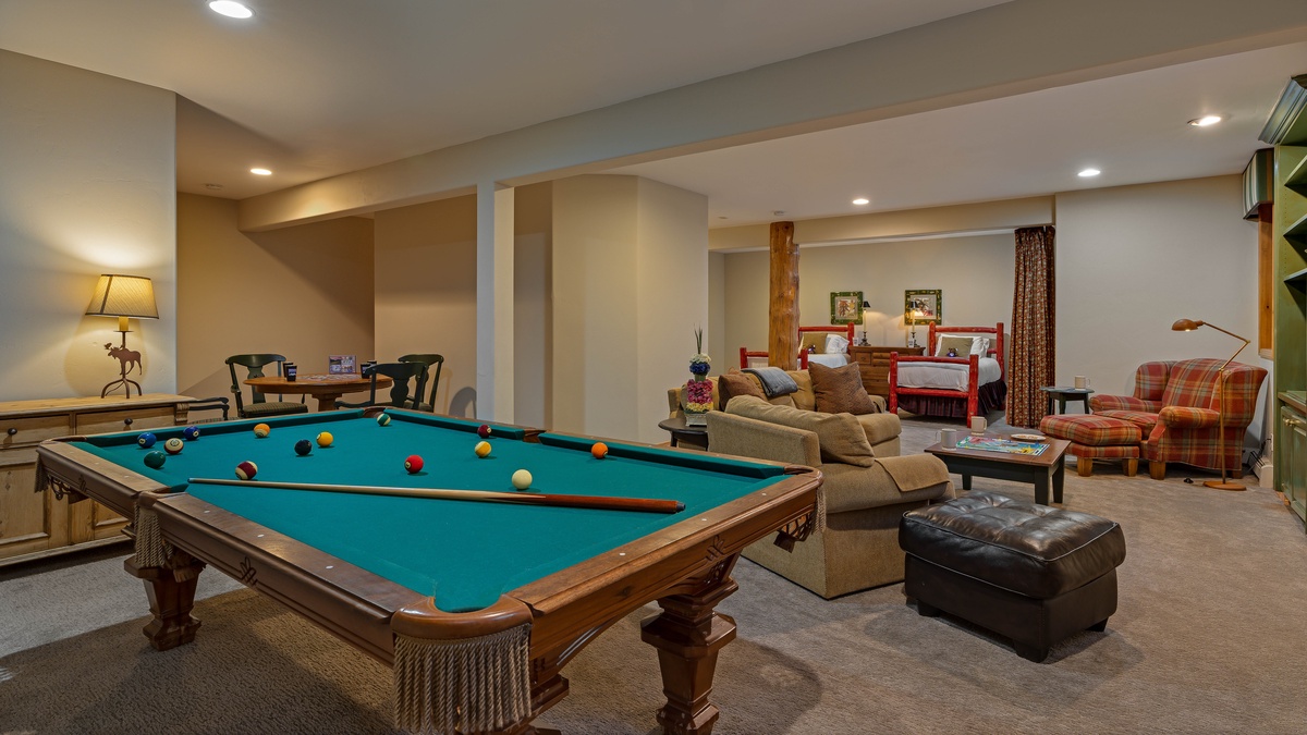 Family room with pool table and twin beds on lower level
