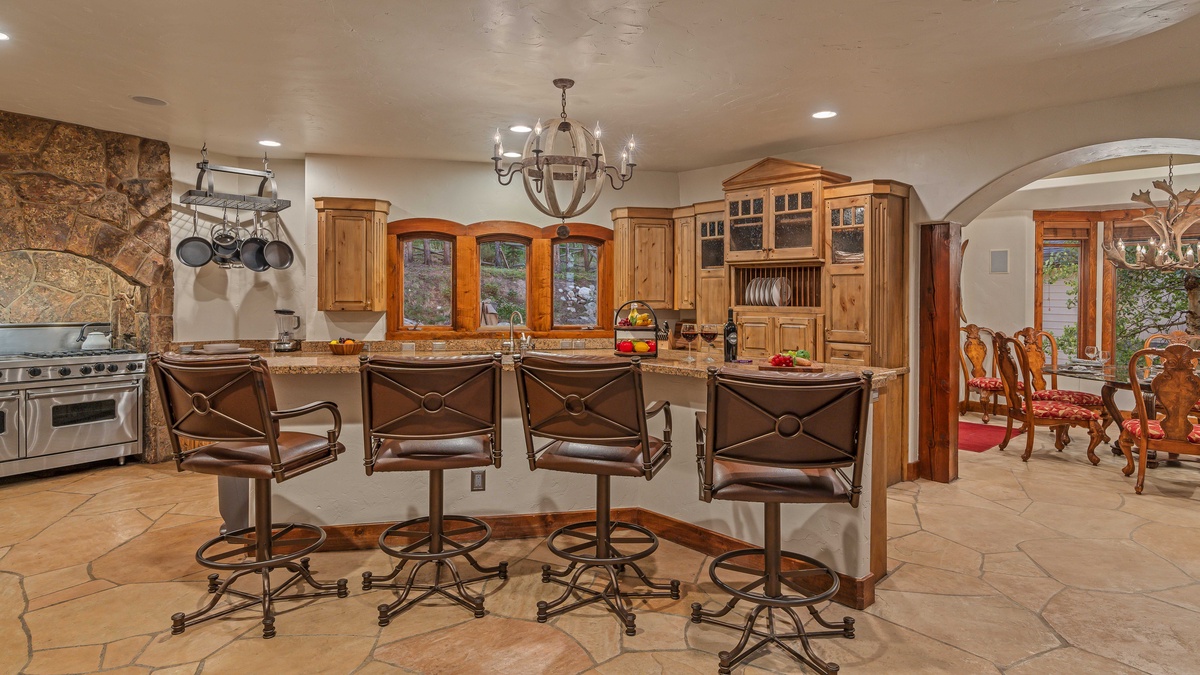Main level kitchen with bar seating and adjacent dining area