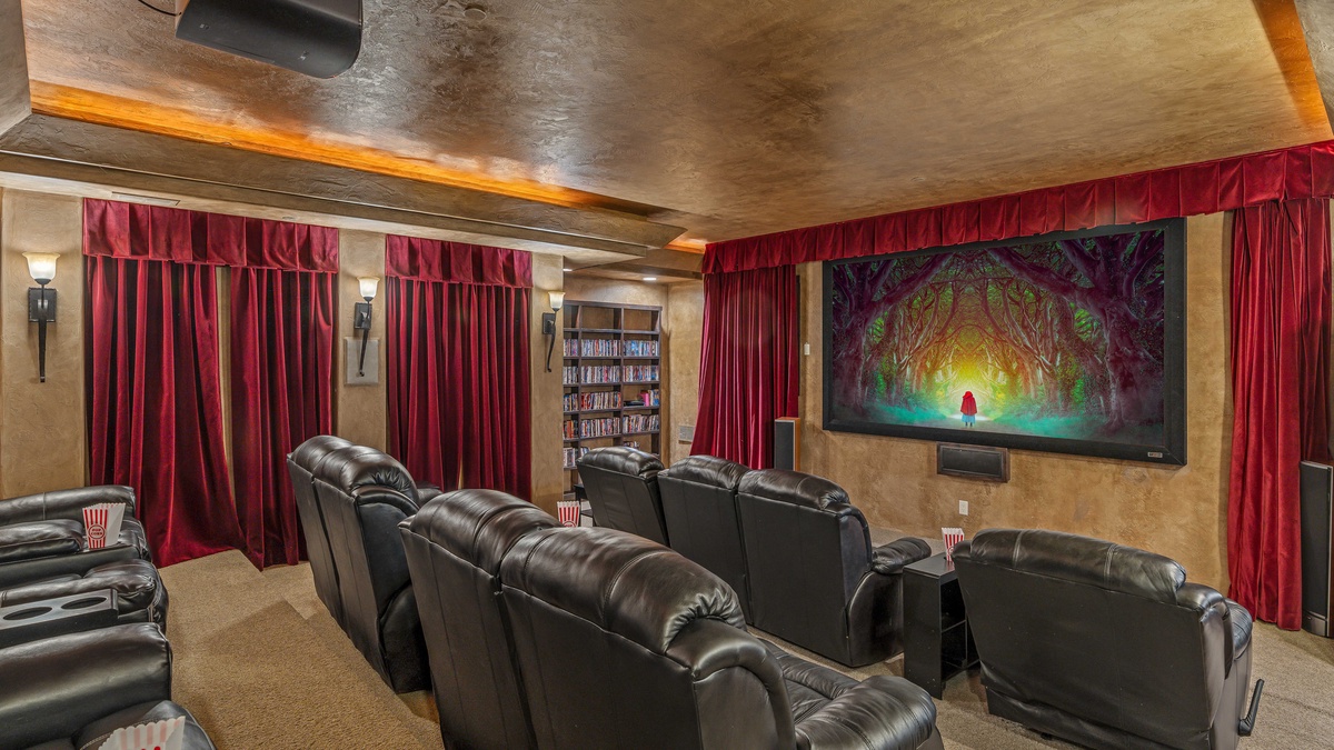 Lower level theatre room with ample plush seating