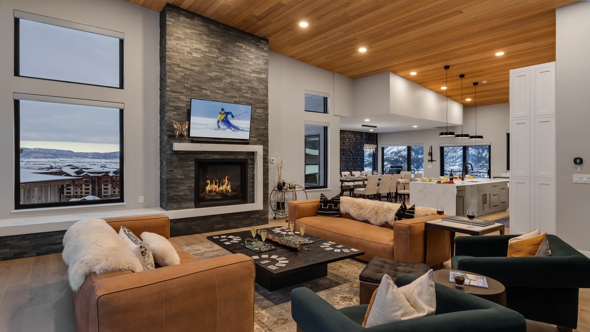 Great room with an open floor plan, fireplace, and TV