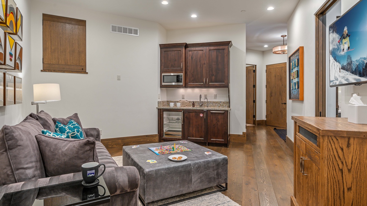 Family room on middle level with wet bar and TV