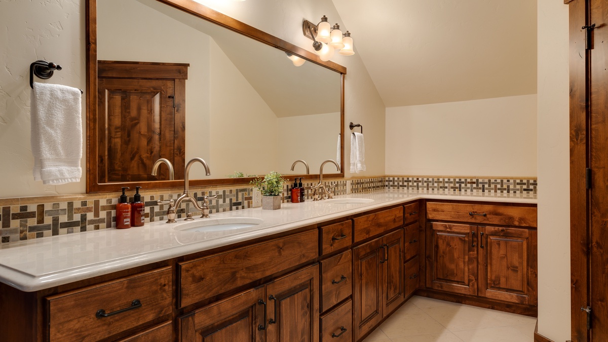 Bedroom 1, Uppermost Level - Primary ensuite with double vanity and wood cabinetry