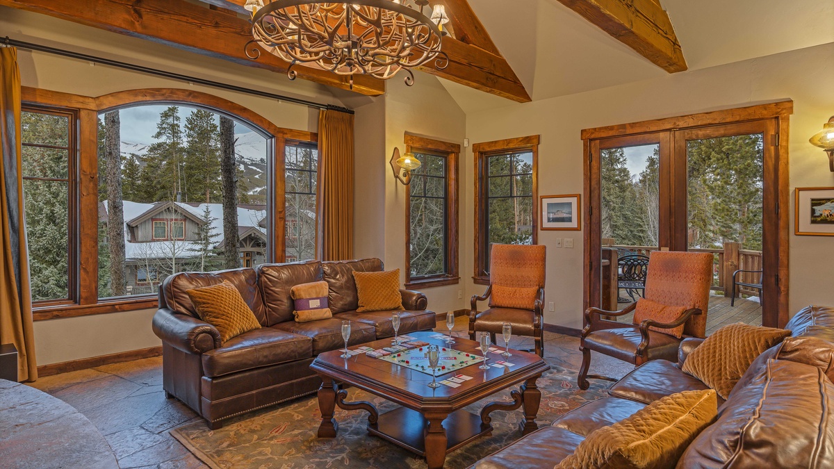 Great room with mountain resort views and deck access
