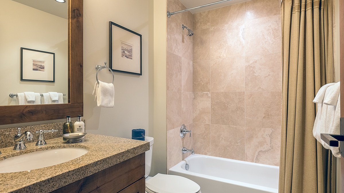 Shared Bathroom, Main Level - Hall bathroom adjacent to Bedroom 4 with single vanity and shower tub combo