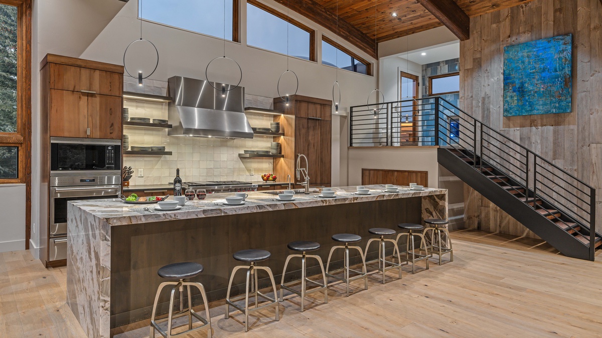 Gourmet kitchen with 6-burner gas range, 3 dishwashers, and bar seating for 7