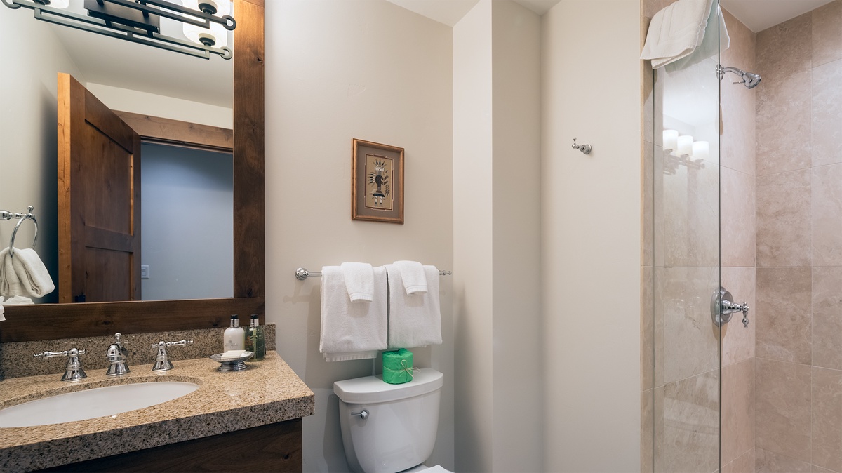 Step into your private spa-like retreat with gleaming granite counters, warm wood accents, and a spacious walk-in shower designed for total relaxation.