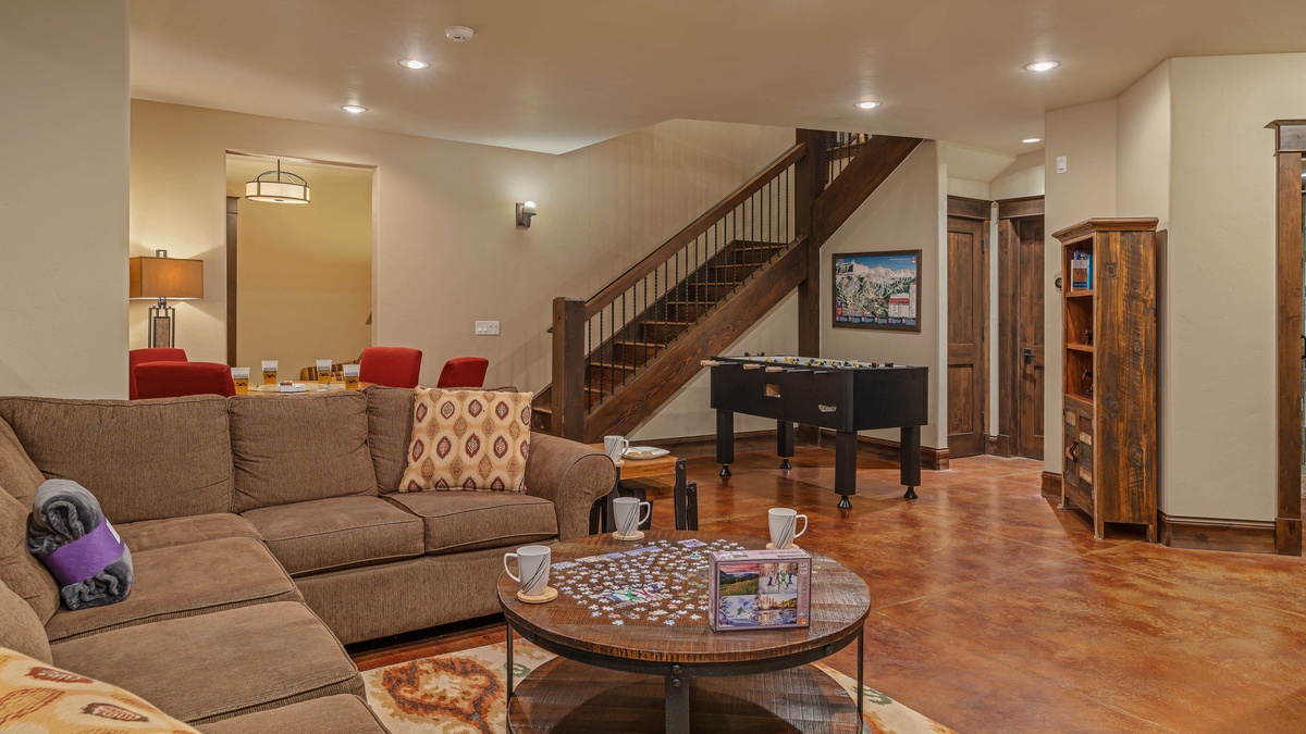 Lower level family room with game table and foose ball