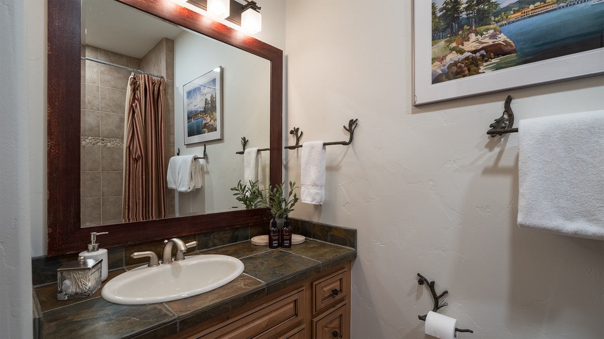 Shared Bathroom, Main Level - Hall bathroom adjacent to Bedroom 2 with single vanity