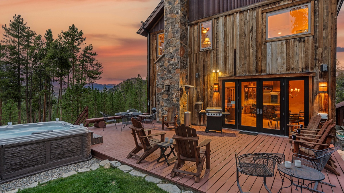 Relax on the back deck with plenty of seating, grill, and hot tub