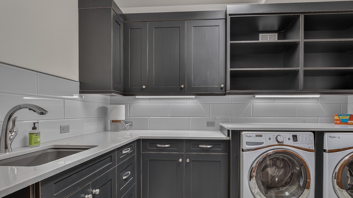 Laundry, Lower Level - Washer and dryer with storage cabinets