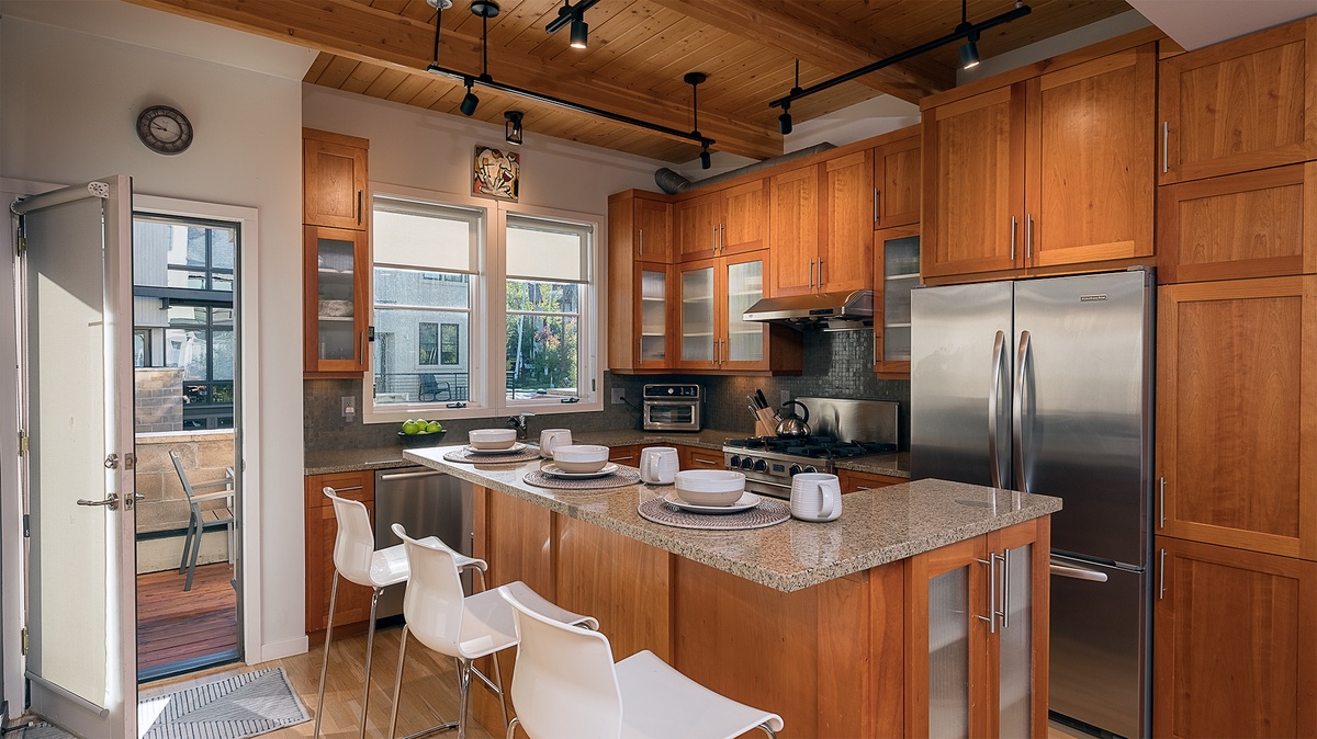 Kitchen, Main Level - Island with bar seating and surrounding cabinetry
