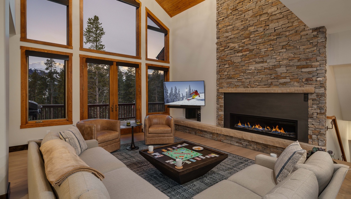 Great room with vaulted ceilings, fireplace, and mountain views