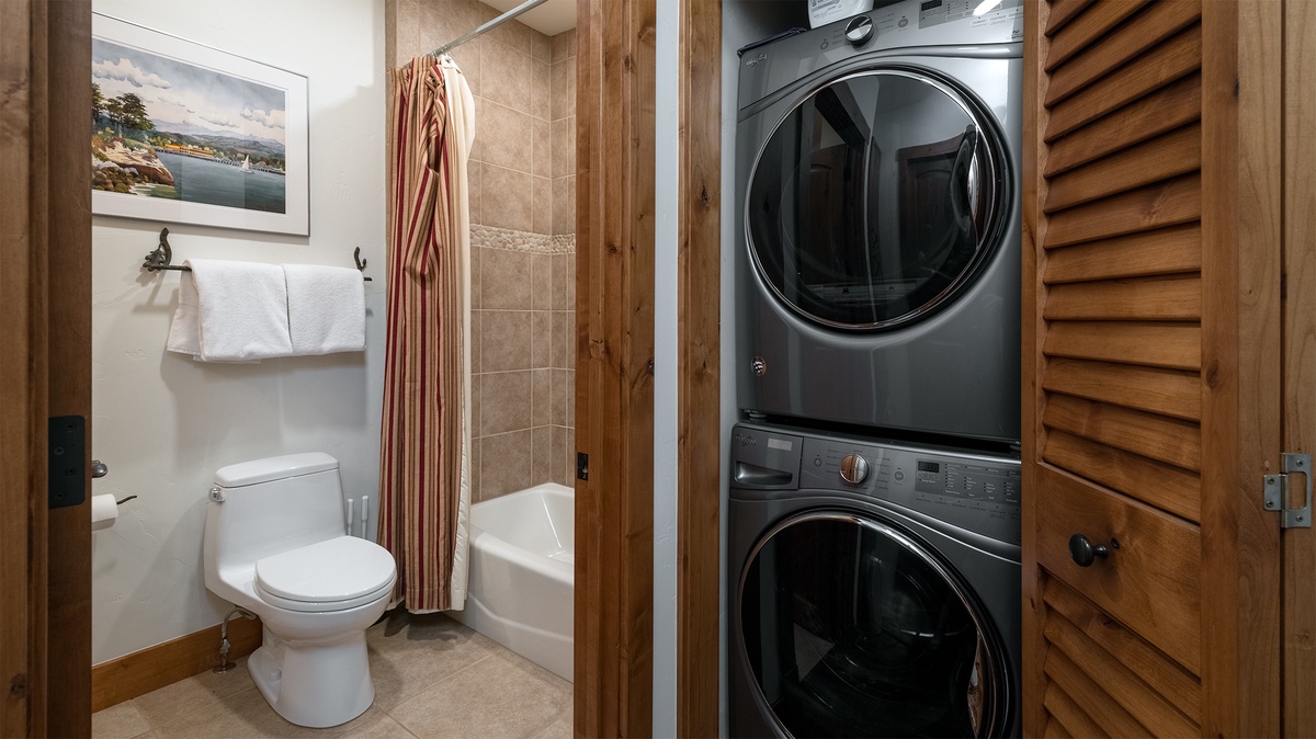 Laundry, Main Level - Stacked washer and dryer with adjacent hall bath