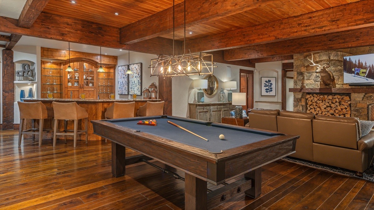 Billiards table and wet bar on lower level