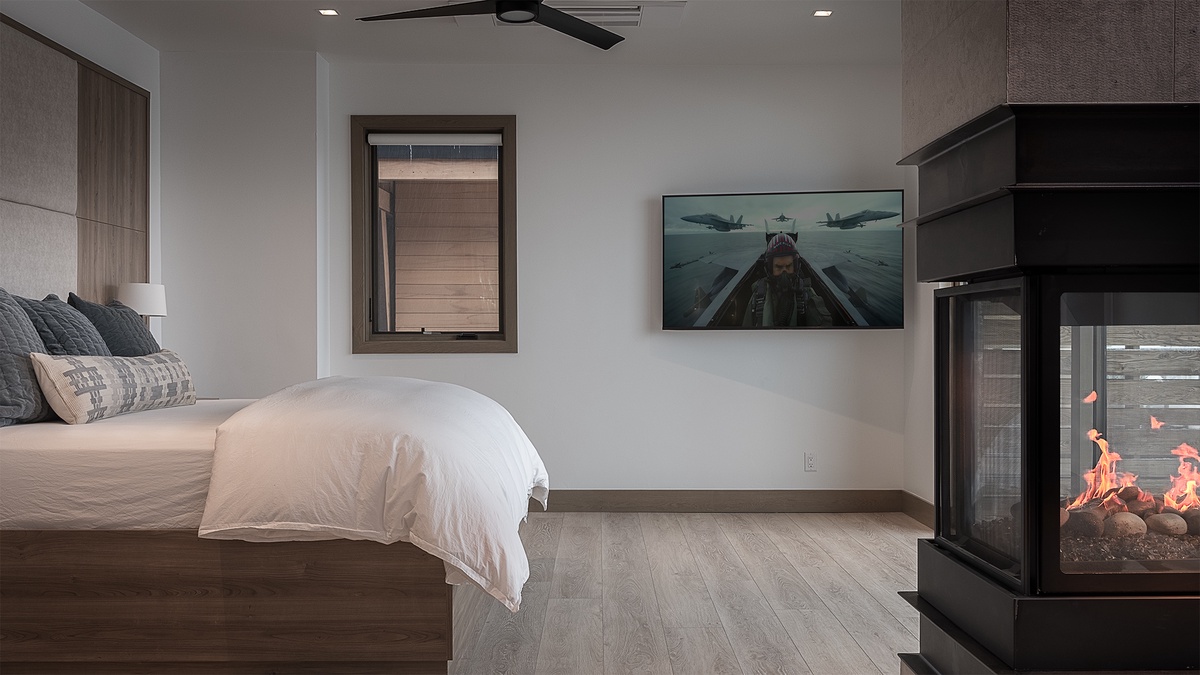 Bedroom 1, Upper Level - Riverlight Lodge primary king suite with modern fireplace