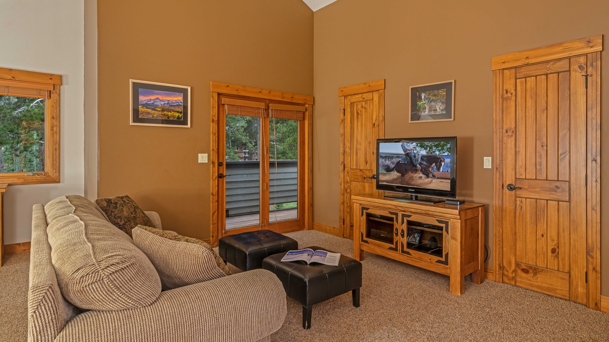 Bedroom 1, Upper Level - Primary king suite with TV, balcony, and queen sleeper sofa
