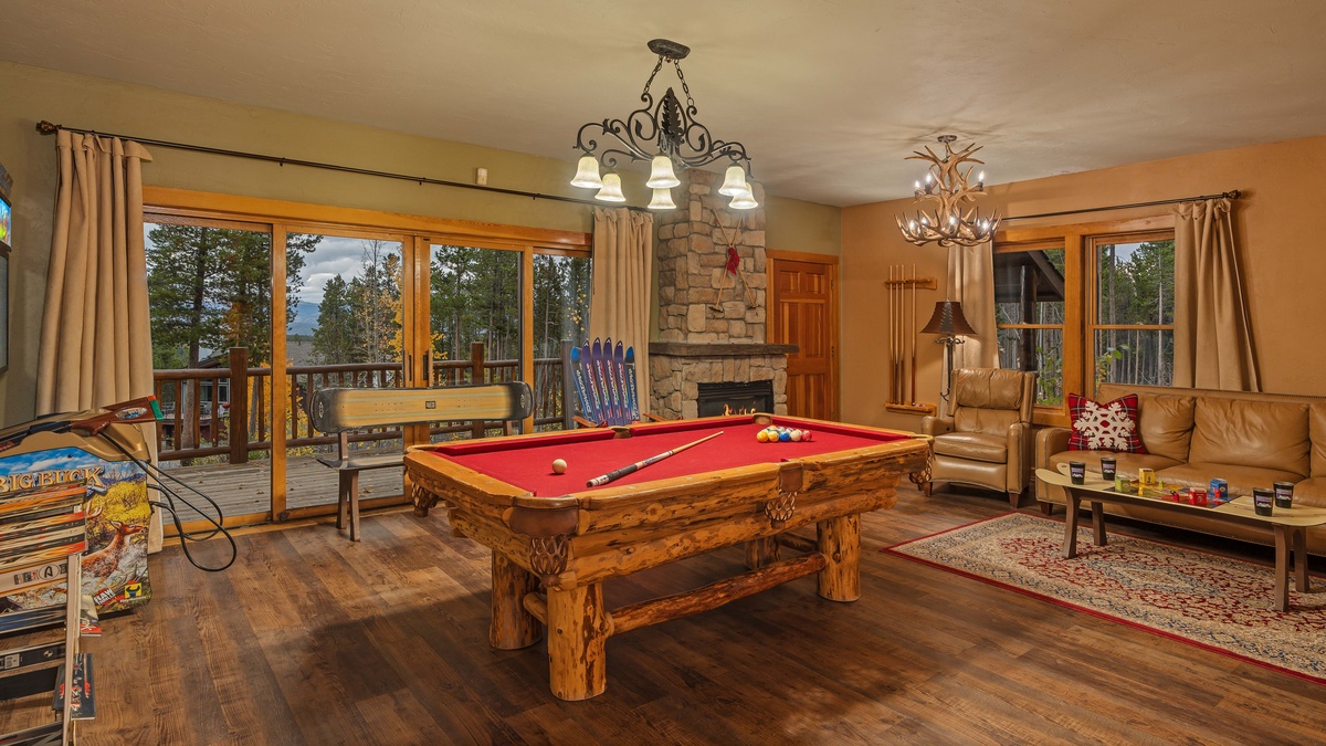 Family room on lower level with pool table and lower deck access
