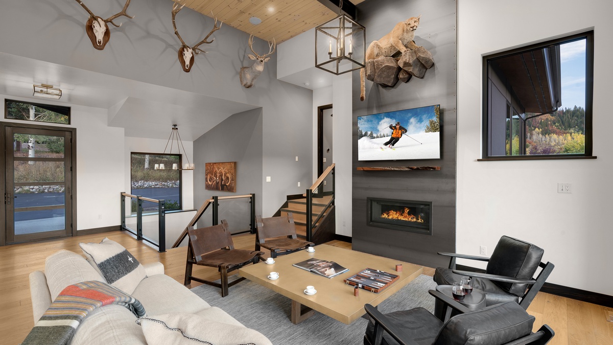 Great Room, Main Level - Wall-mounted TV with fireplace and seating area