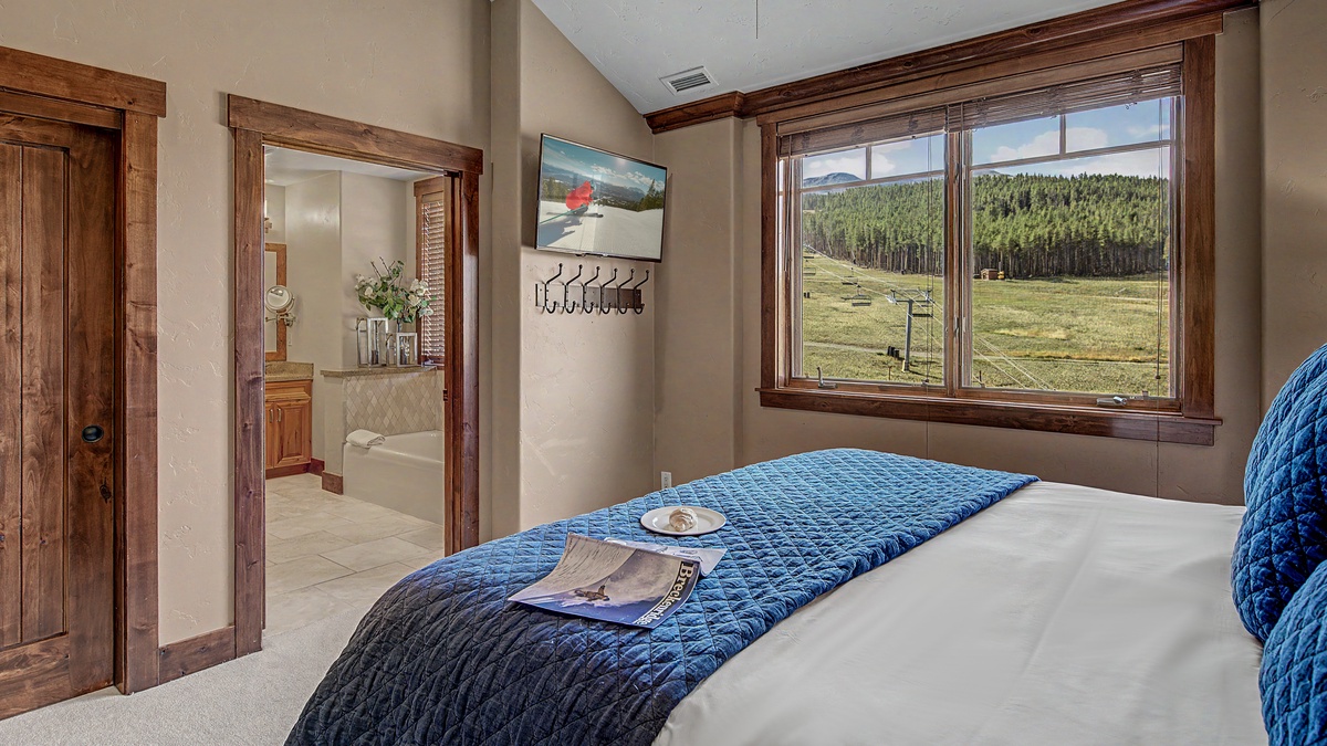 Bedroom 1, Main Level - Primary king bedroom with ensuite access and mountain views