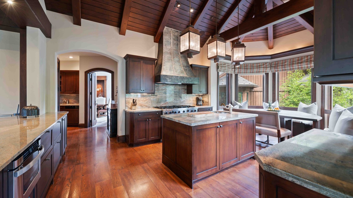 The chef's kitchen with gas stove, walk-in refrigerator and breakfast nook