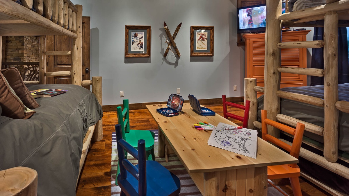 Bunkroom on upper level with 2 twin/twin bunk beds, two trundle beds, TV and game table