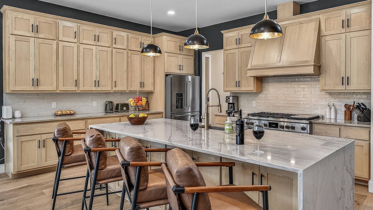 Kitchen, Main Level - Large island with bar seating and modern appliances
