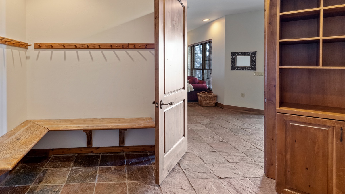 Convenient gear storage room with boot heaters next to garage