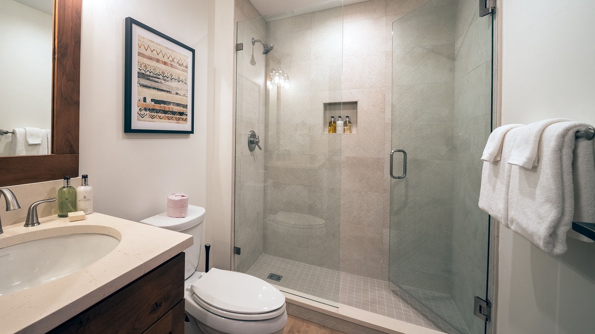 Shared Bathroom, Main Level - Hall bathroom adjacent to Bedroom 4 with single vanity and walk-in shower