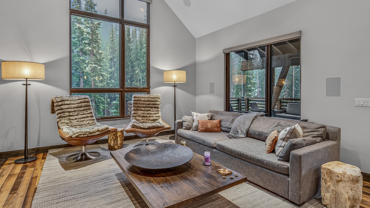 Great Room, Main Level - Seating area with sofa, chairs, and forest views