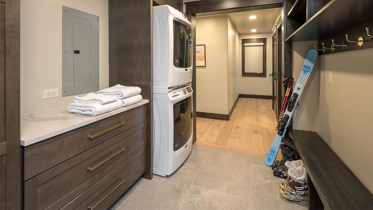 Laundry, Lower Level - Stacked washer and dryer with storage cabinet