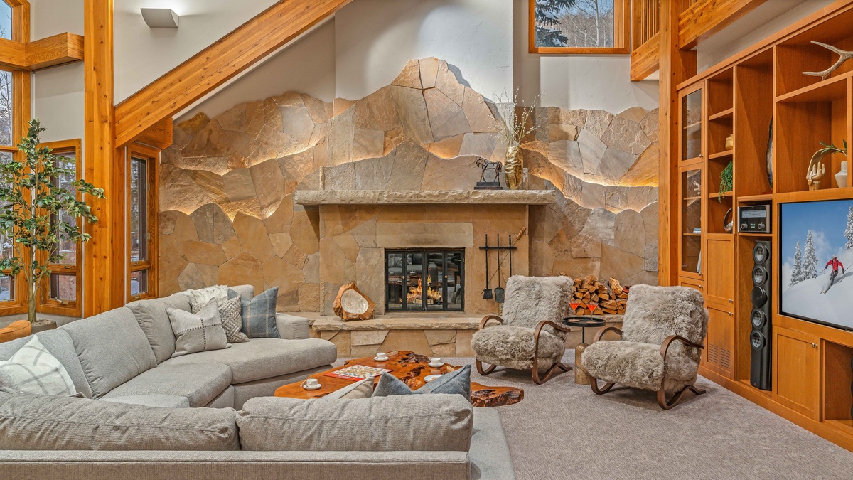Stunning great room on main level with fireplace and custom stonework