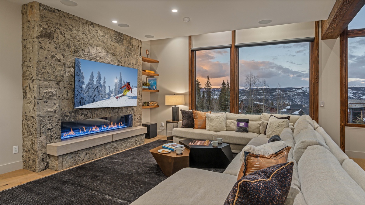 Luxurious sectional with TV and gas fireplace on the mid-level family room
