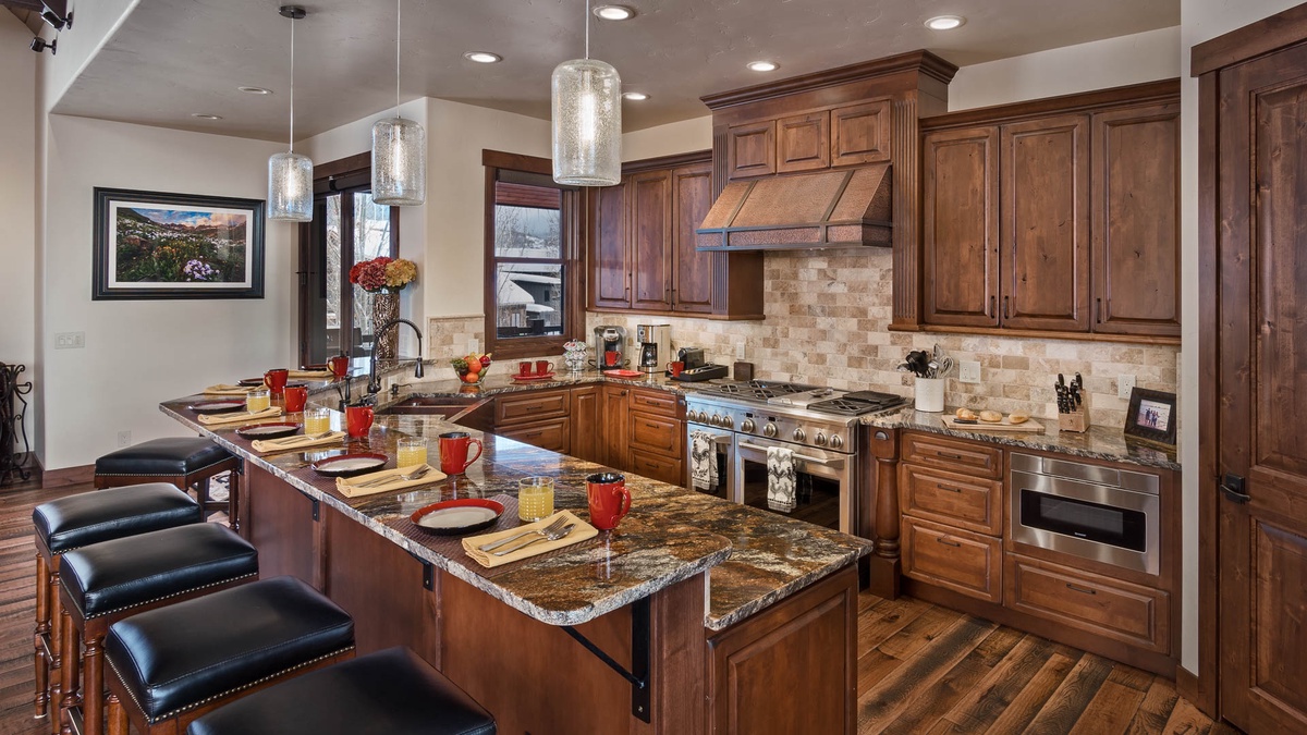 Kitchen, Upper Level - Island with bar seating and wood cabinetry