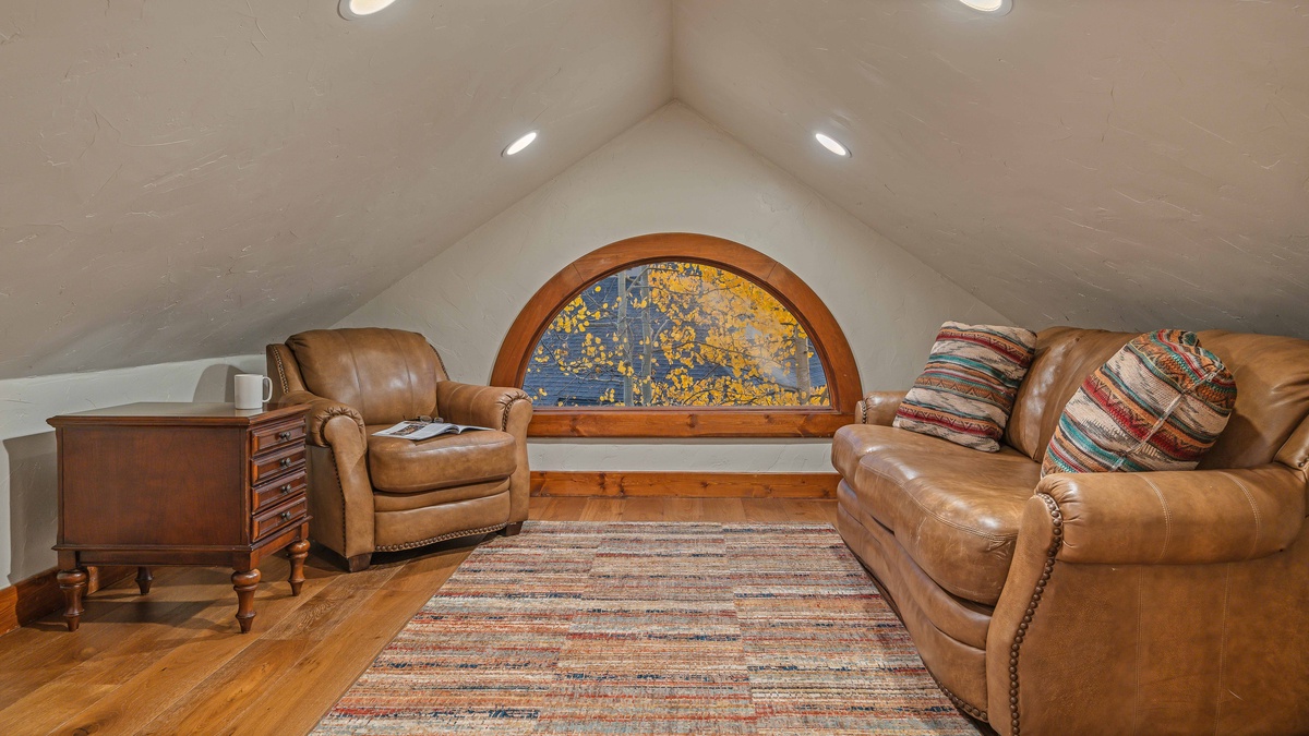 Loft sitting area on upper level with full sofa bed
