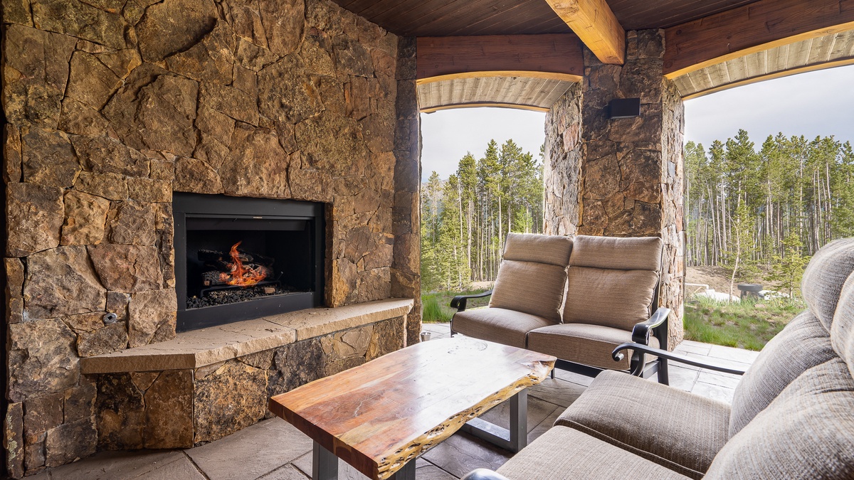 Outdoor living room just outside the rec room with gas fireplace and overhead heaters