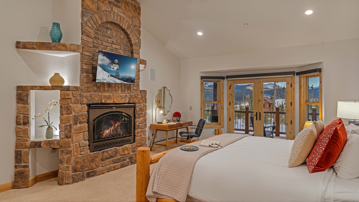 Bedroom 1, Lower Level - Gorgeous primary king suite on main level with TV, fireplace, and deck access