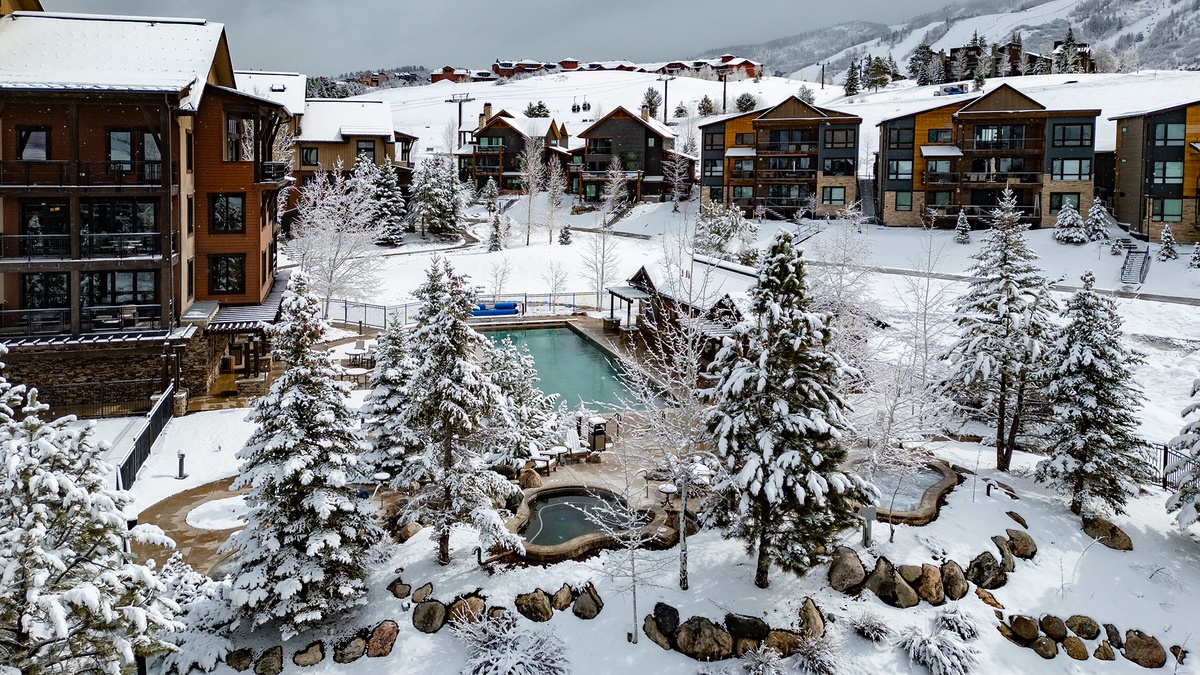 Aerial view of community pools with mountain backdrop